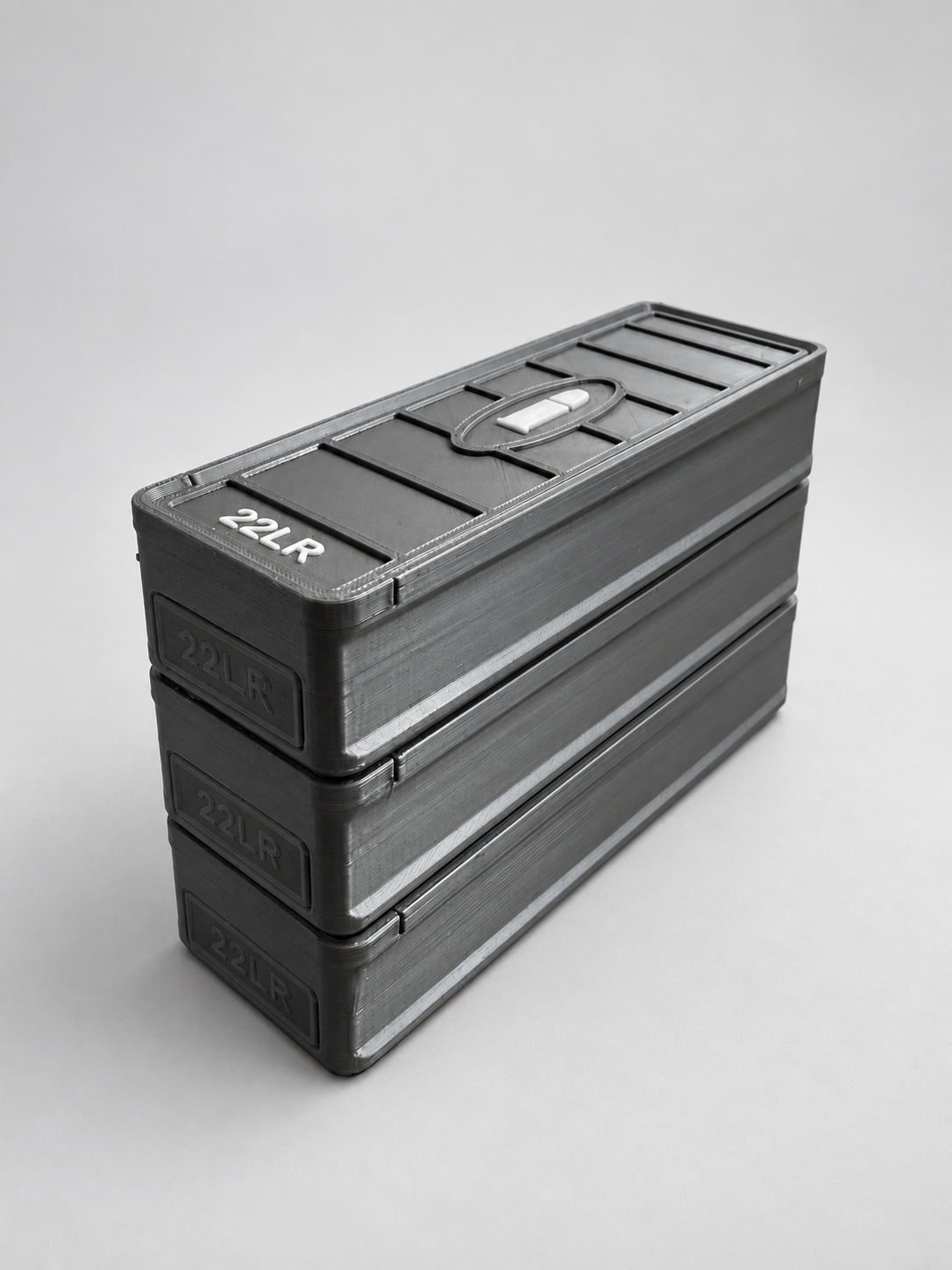 Three stacked gray .22 LR ammunition storage boxes