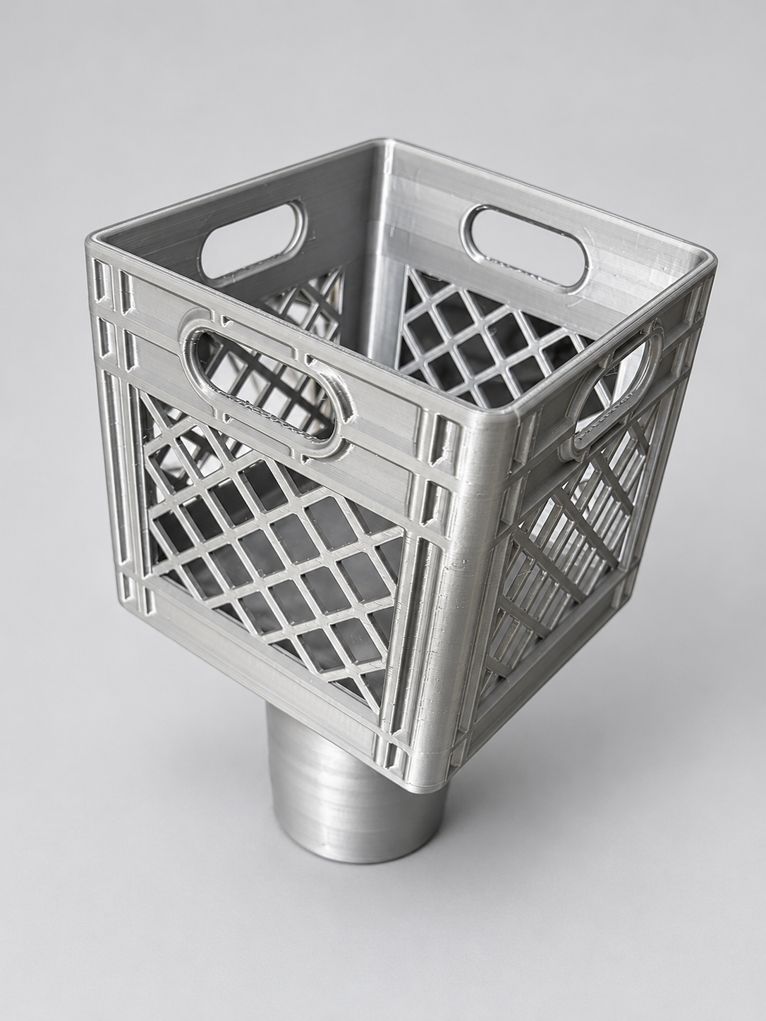 Silver-gray crate-style cup holder insert with lattice sides and a cylindrical base